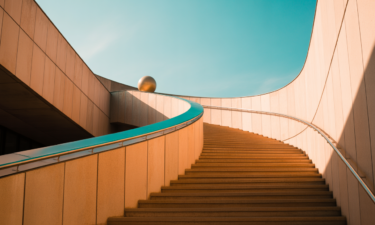 A staircase rising up to an open sky
