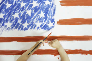 The child hands drawing the American flag. Concept of independence day, July 4.