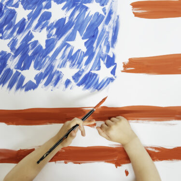 The child hands drawing the American flag. Concept of independence day, July 4.