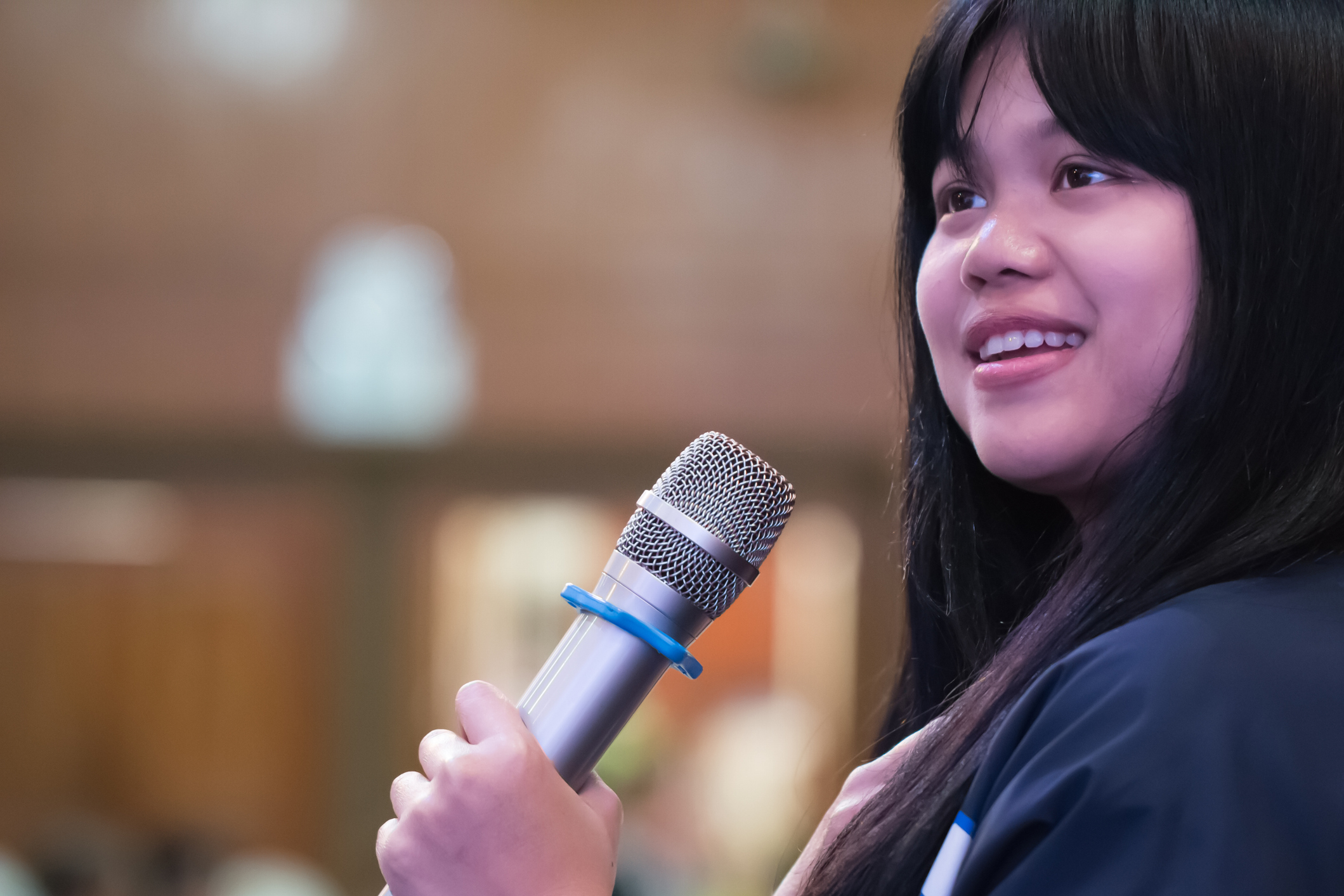 Smart Businesswoman speech or Speaking with microphone in Seminar hall, hand gesturing protesting or belief for explaining in conference room. Speaker tedtalk is vocalized form of communication humans